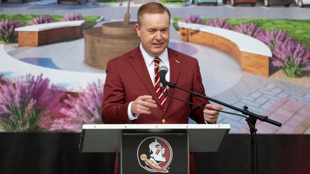 Florida State athletic director Michael Alford speaks at a podium